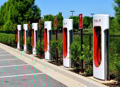 “Tesla EV charging stations installed along a parking lot at a commercial location”
