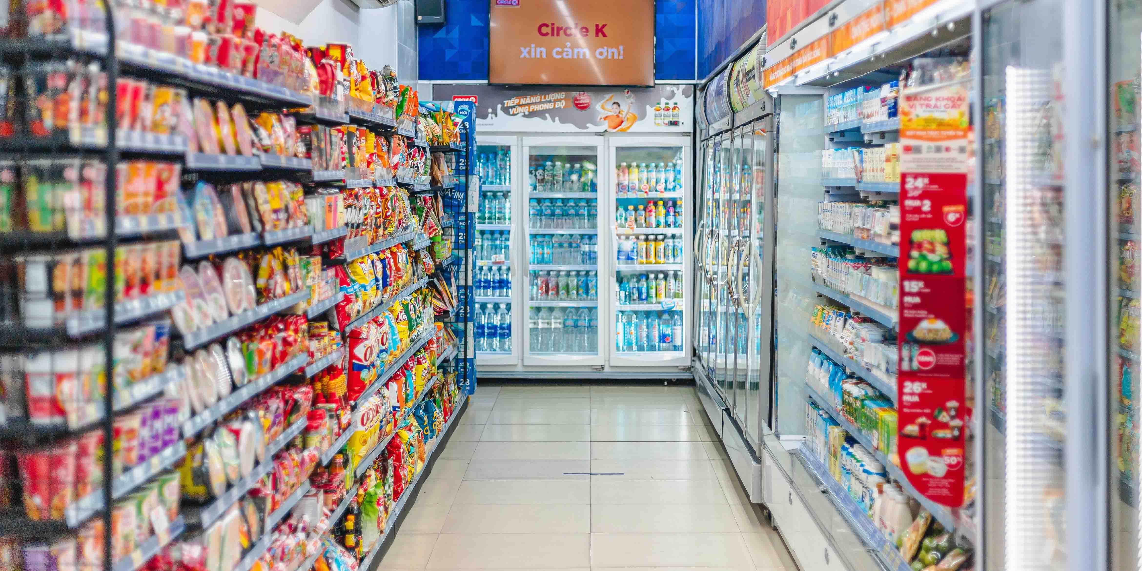 Convenience store shelves lined with chips, candy, and other popular snacks